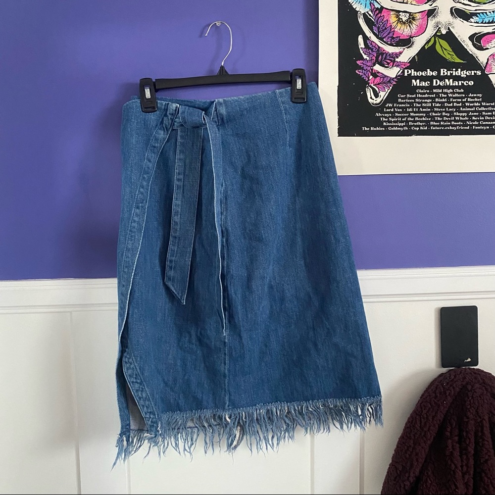 medium wash blue denim wrap skirt w/ pocket and distressed fringe
